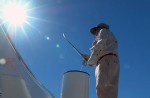 Lefty Kreh casting off the deck of a boat while using a modified stripping basket