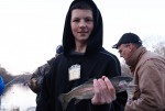 a young angler with a fist full of rainbow trout