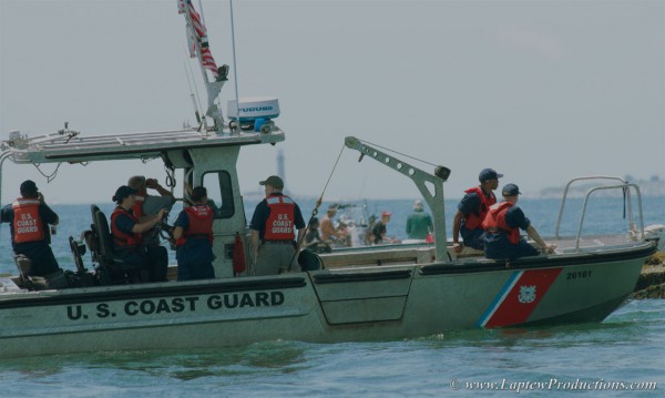 Coast Guard crew carefully approaches the lighthouse for a visit.